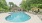 Pool with sundeck and orange umbrellas